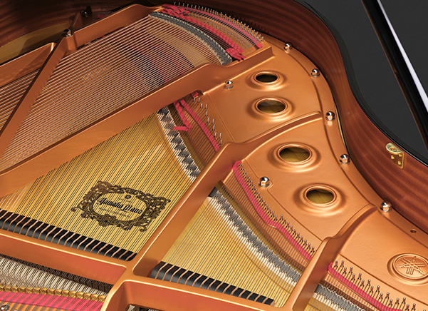 Interior of the Yamaha GCB grand piano showing its soundboard, strings and structural design