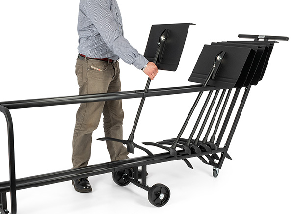 Person placing a stand on a stand trolley