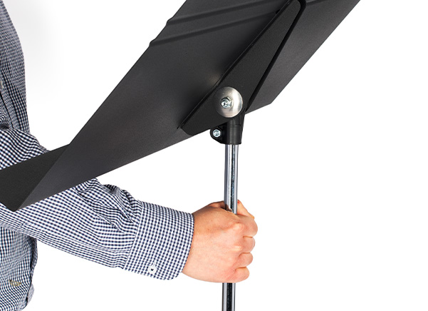 Person adjusting a Manhasset stand height with one hand