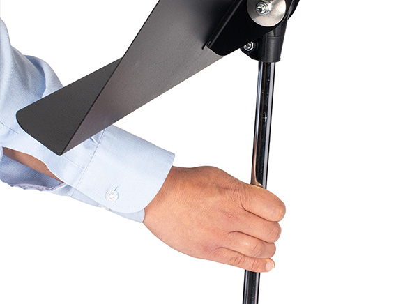 Person adjusting stand height with one hand