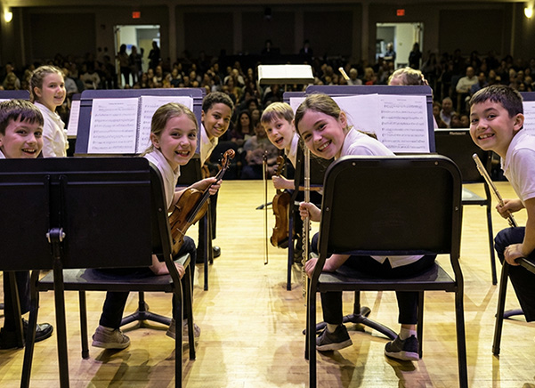 School orchestra on stage using Manhasset stands