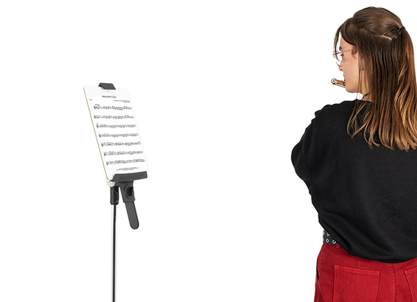 Person playing an instrument in front of the tablet stand