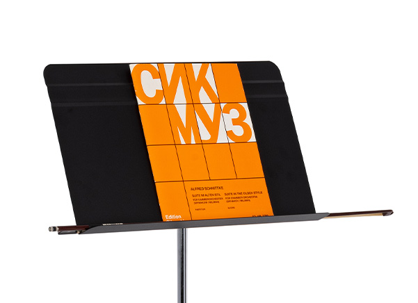 Close up of music stand desk with music and violin bow